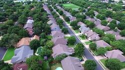 AERIAL: Flying Over Local Austin Texas Housing Complex with natural Trees and Texas Hill Country feel backing up Stock Footage
