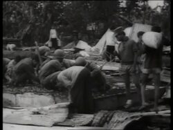 B/W 1960's soldiers look thru debris of destroyed village / Vietnam / SOUND Stock Footage