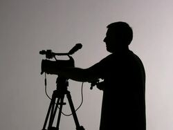 (HD1080i)  Videographer Cameraman Shooting and Directing; Silhouette Stock Footage