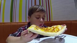 Boy eating a pizza Stock Footage