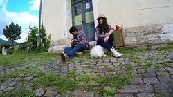 Young couple in love playing acoustic guitar in the park Stock Footage