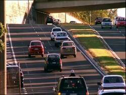 MS dual carriageway, cars move away from camera, Sydney, Australia Stock Footage
