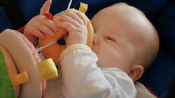 baby chewing a toy made of cloth Stock Footage
