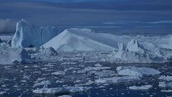Ice flowing rapidly towards the sea with pan to left Stock Footage