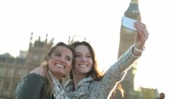 Friends pose for a photo together in front of the London Parliament Buildings. Stock Footage