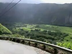 WS POV T/L View of car going down Waipio Valley with Hiilawe Fall at back of valley / Waipio, Hawaii, USA Stock Footage