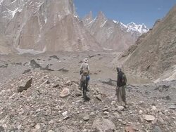 Climbers at lake in valley, Himalayas Stock Footage