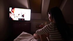 Young woman watching while eating chips. Stock Footage