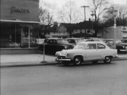 1952 Henry J parks in front of Kaiser-Frazer bldg. Stock Footage