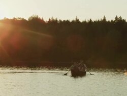 WS TS View of Couple canoeing at sunset on Long Pond / Maine, United States Stock Footage