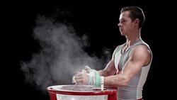 SLO MO Male gymnast clapping wrapped hands over chalk bowl Stock Footage