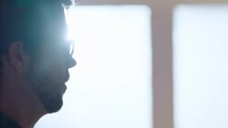 Young business owner hangs price tags around colorful skateboard wheels on display in shop Stock Footage