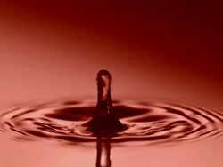 HD Super Slow-Mo: Drop Dripping Into Red Water Stock Footage