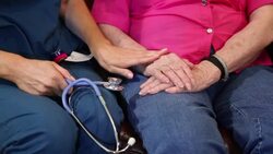 Home healthcare nurse comforts senior woman. Hands. Stock Footage