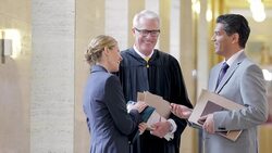 Lawyers shaking hands in courthouse hallway Stock Footage