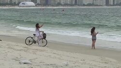 CLEAN : On Copacabana beach tourists and locals happy with Olympics News Clip