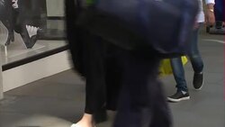 Woman with Karl Lagerfeld bag next to Chanel shop News Clip