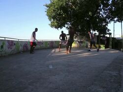 Group Of Local Residents Play Football In Mangueira Favela Stock Footage