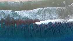 Overhead view of gentle waves breaking on Pacific Atoll Stock Footage