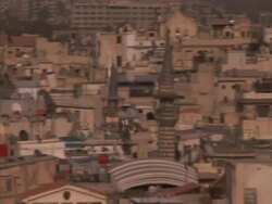 Tracking flock of birds flying over Arabic townscape, Umayyad mosque tower, Syria (sound available) Stock Footage