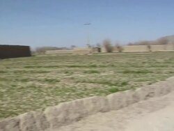 WS ZI PAN Soldier walking on dirt track / Musa Qala, Helmand Province, Afghanistan. Stock Footage