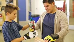Hispanic father or instructor in woodworking workshop instructs preteen boy with project Stock Footage