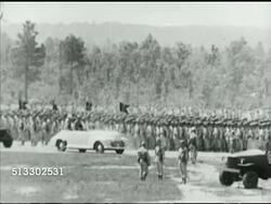 1942: FORT JACKSON REVIEW: WS TRACKING British Prime Minister Winston Churchill & officers riding on back of & in convertible past troops.    WWII, Allied, training, airborne, parachute infantry, reviewing. Instructional Video