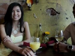 MS Young woman sitting  with  guy drinking beverages  in restaurant  / Minneapolis, Minnesota, United States Stock Footage