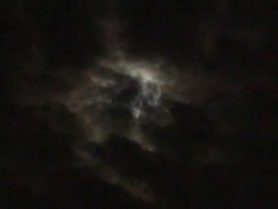 Video of Clouds Passing by a Full Moon Stock Footage