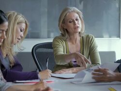 MS PAN Team leader discussing with papers at meeting / New York City, New York, USA Stock Footage
