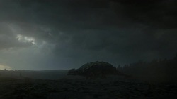 Storm clouds loom over  a field where an armored dinosaur grazes in a computer generated animation. Stock Footage