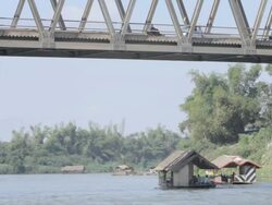 WS boats going under bridge / Tha Ngon, Laos Stock Footage