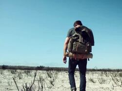 Backpacker walking through the desert Stock Footage