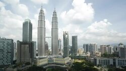 Clouds cast shadows as they drift over the Petronas Twin Towers in the Kuala Lumpur financial district. Stock Footage