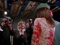 Low angle medium shot tracking shot bodyguard opening rope / famous couple walking among groupies and press / signing autographs Stock Footage