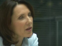 Pffice workers looking at laptop and having conversation; UK Stock Footage