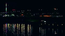 Ferris wheel reflection in river at night Stock Footage