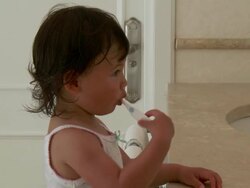 CU Shot of little metis girl is brushing her teeth in bathroom / Marbella, Andalusia, Spain Stock Footage