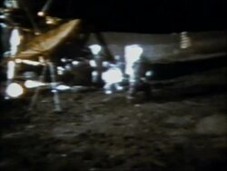 1971 wide shot astronaut Alan Shepard swinging a soil sampler like a golf club on the surface of the moon Stock Footage