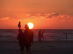 WS View of people walking near sea coast during sunset, North Sea North Frisia, / St. Peter Ording, Schleswig Holstein, Germany Stock Footage