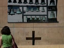 (HD1080i) CrossWalk: Woman Walks to Reveal Cross in Wall Stock Footage