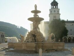 MS Residenzplatz (Residence Square) with Residenzbrunnen. The fountain was executed by Tomasso di Garona between 1656 to 1661. It is made of marble, considered the largest baroque fountain of Central Europe. Neue Residenz in background Stock Footage