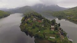 Aerial flight over a mountain river island Stock Footage