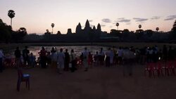 A crowd of tourists gather at the temples of Angkor Wat at golden hour. Stock Footage