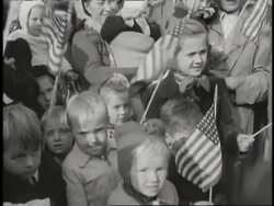 A group of young children wave U.S. flags. News Clip