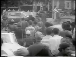B/W 1959 REAR VIEW Fidel Castro followed by crowd walking on street / post-revolution Havana / news. Stock Footage