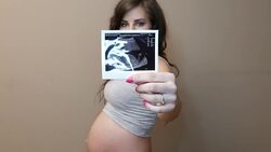 pregnant woman with an ultrasound image Stock Footage