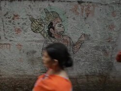 MS People walking by painting of Hindu Monkey God / Varanasi, India Stock Footage
