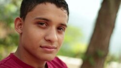 Hispanic teenager smiles at camera Stock Footage