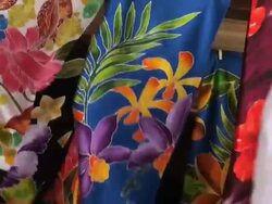 Colorful flapping pareos exposed at a windy market Stock Footage